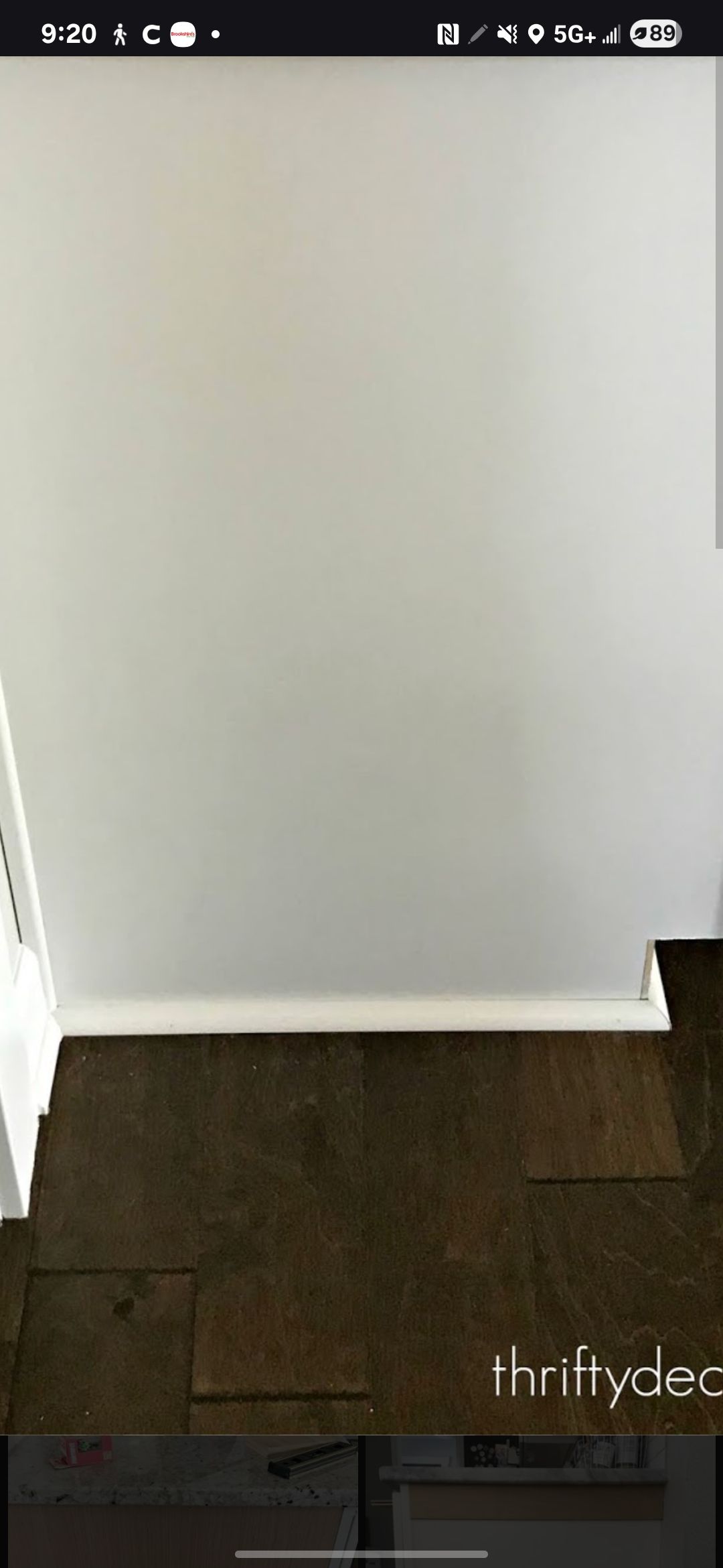 White wall meeting dark floor with white trim.