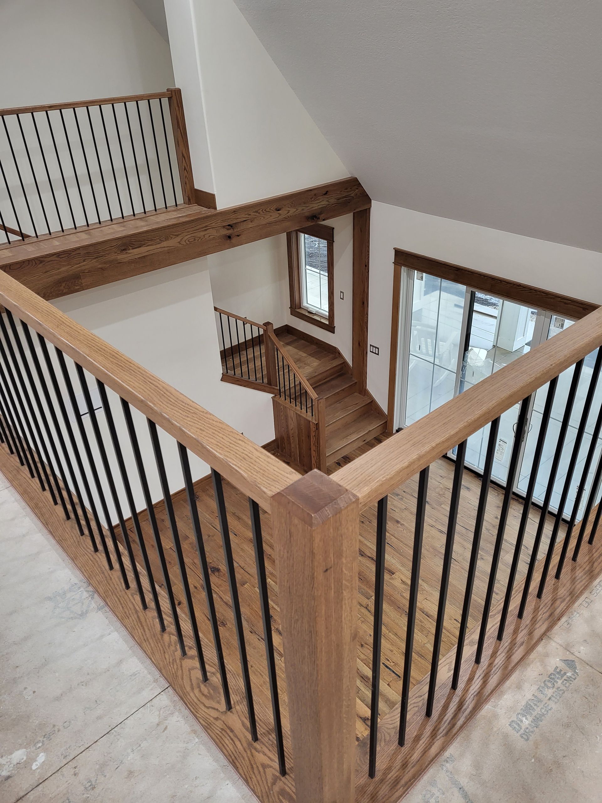 A wooden staircase with a metal railing in a house.