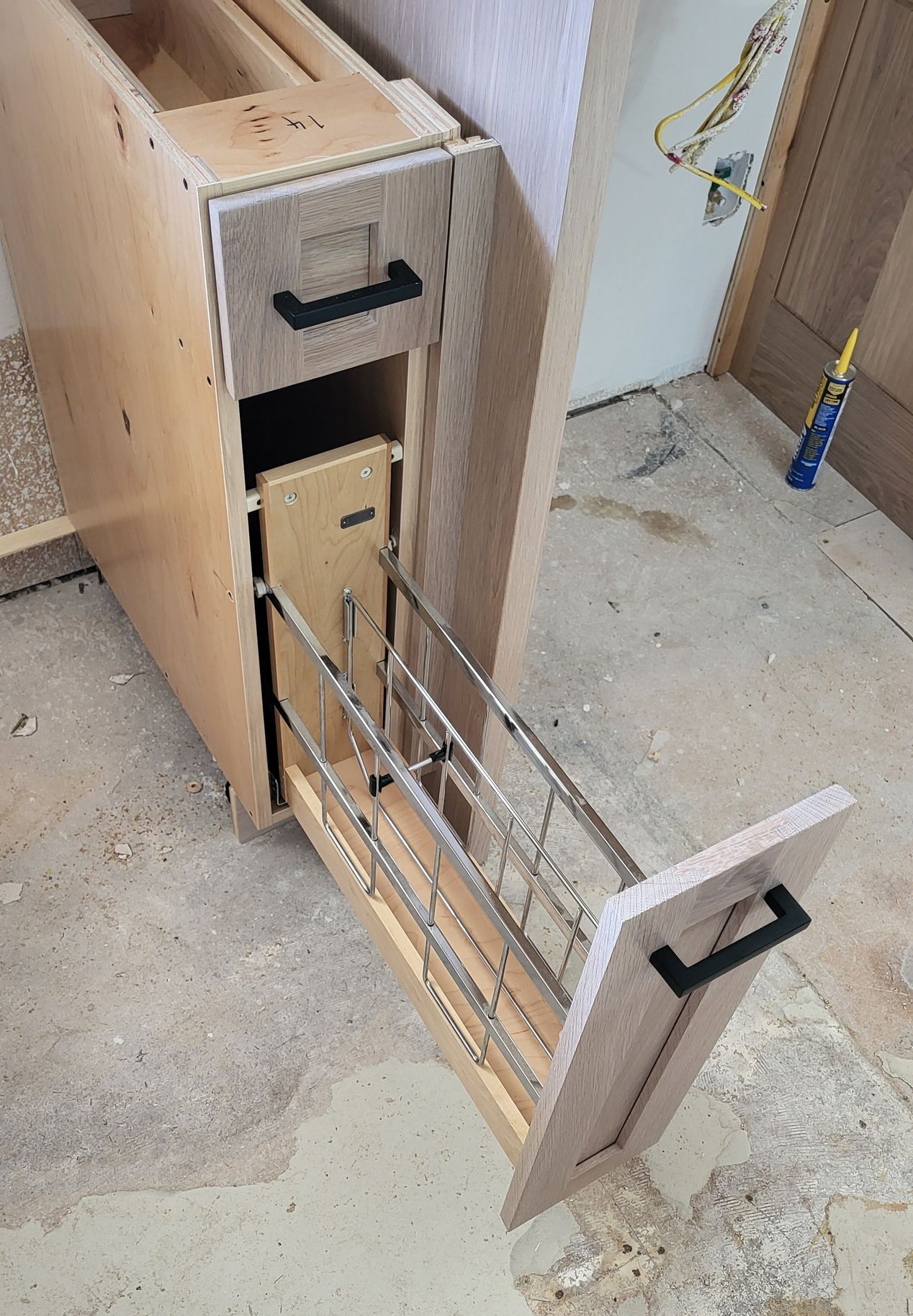 A wooden cabinet with a drawer pulled out of it.