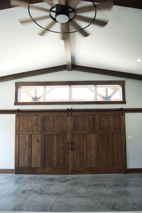 A room with a wooden door and a ceiling fan