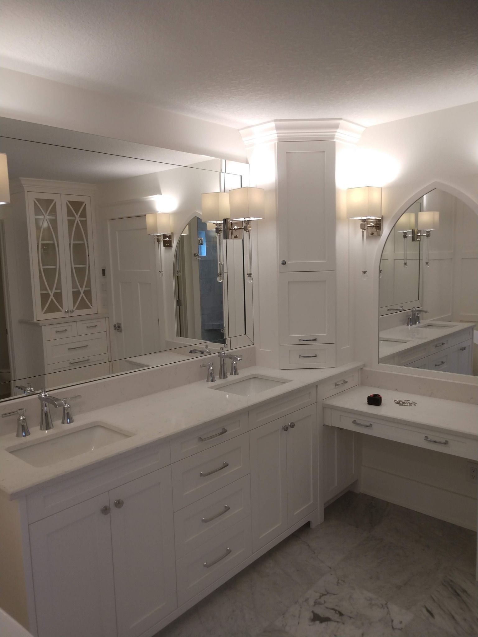 A bathroom with two sinks and a large mirror