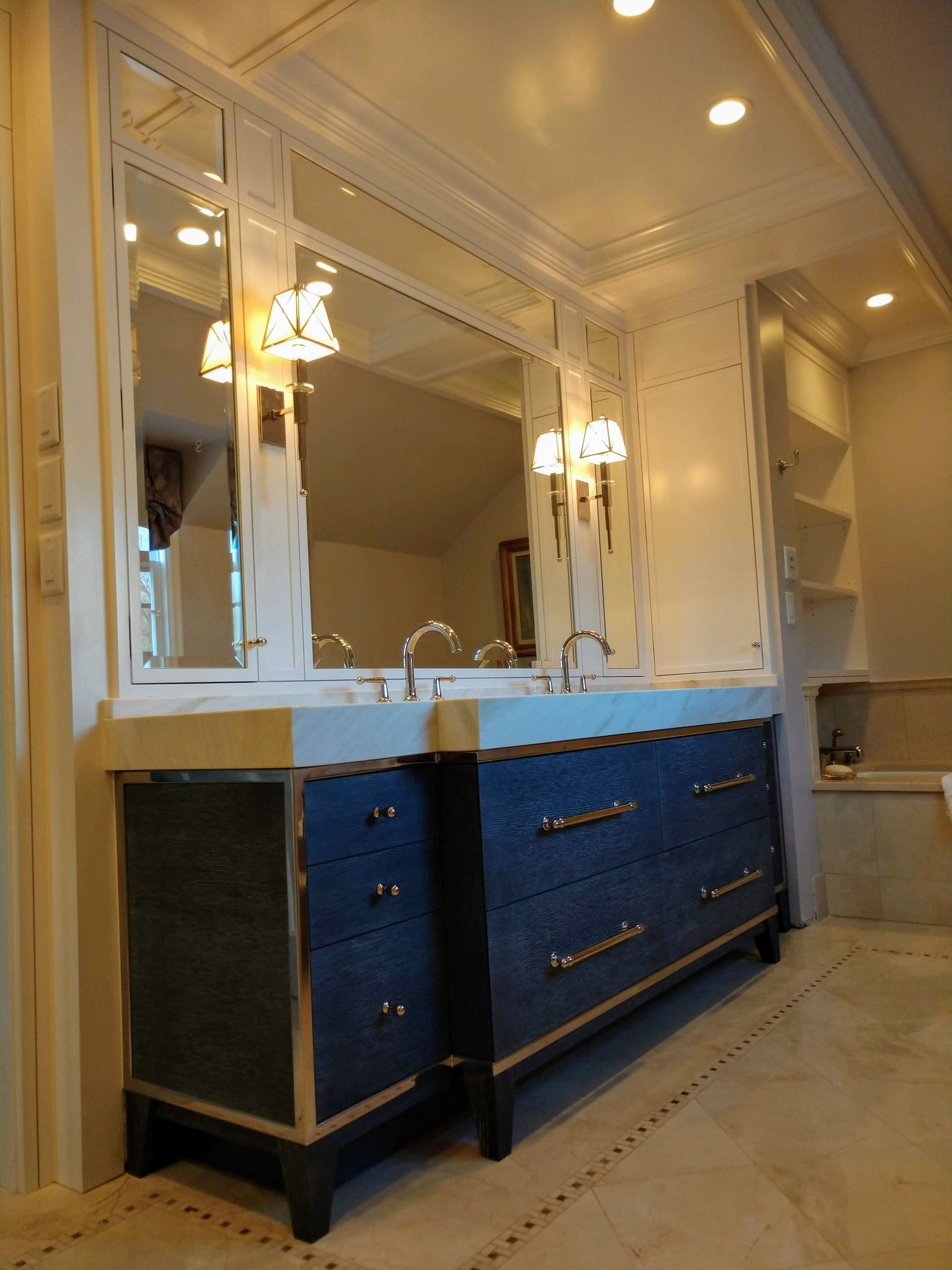 A bathroom with two sinks and two mirrors