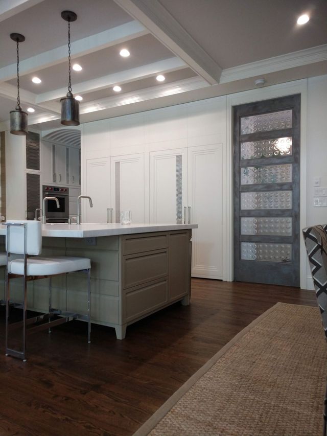 A kitchen with a large island and a sliding glass door