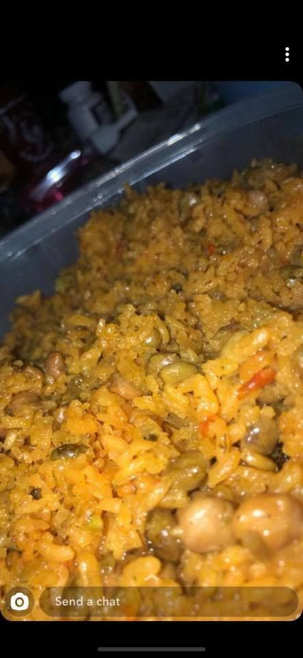 Close-up of a container of yellow rice with beans.