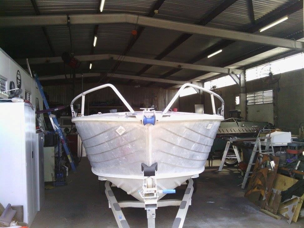 A Boat Is Sitting On A Trailer In A Garage — DJ Welding & Services in Currajong, QLD