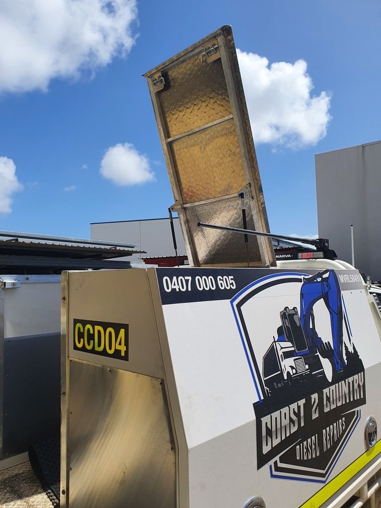 A Red Atv Is Parked In A Parking Lot Next To A Boat — DJ Welding & Services in Currajong, QLD