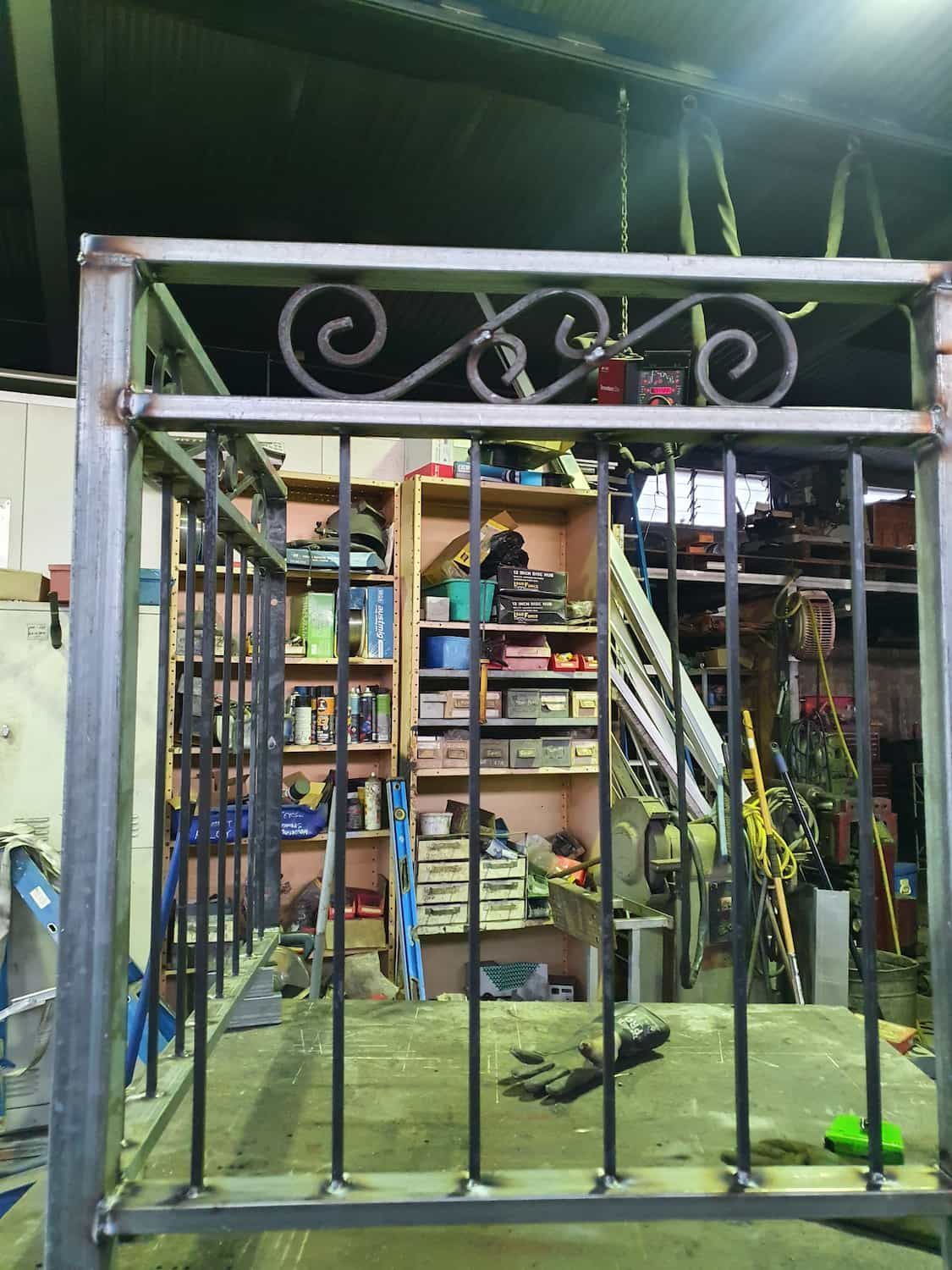 A Metal Fence Is Being Built In A Workshop — DJ Welding & Services in Currajong, QLD