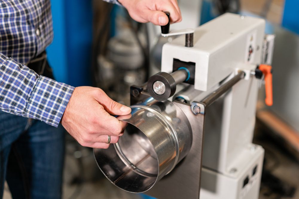 A Large Black Object Is Sitting In Front Of A Building — DJ Welding & Services in Currajong, QLD