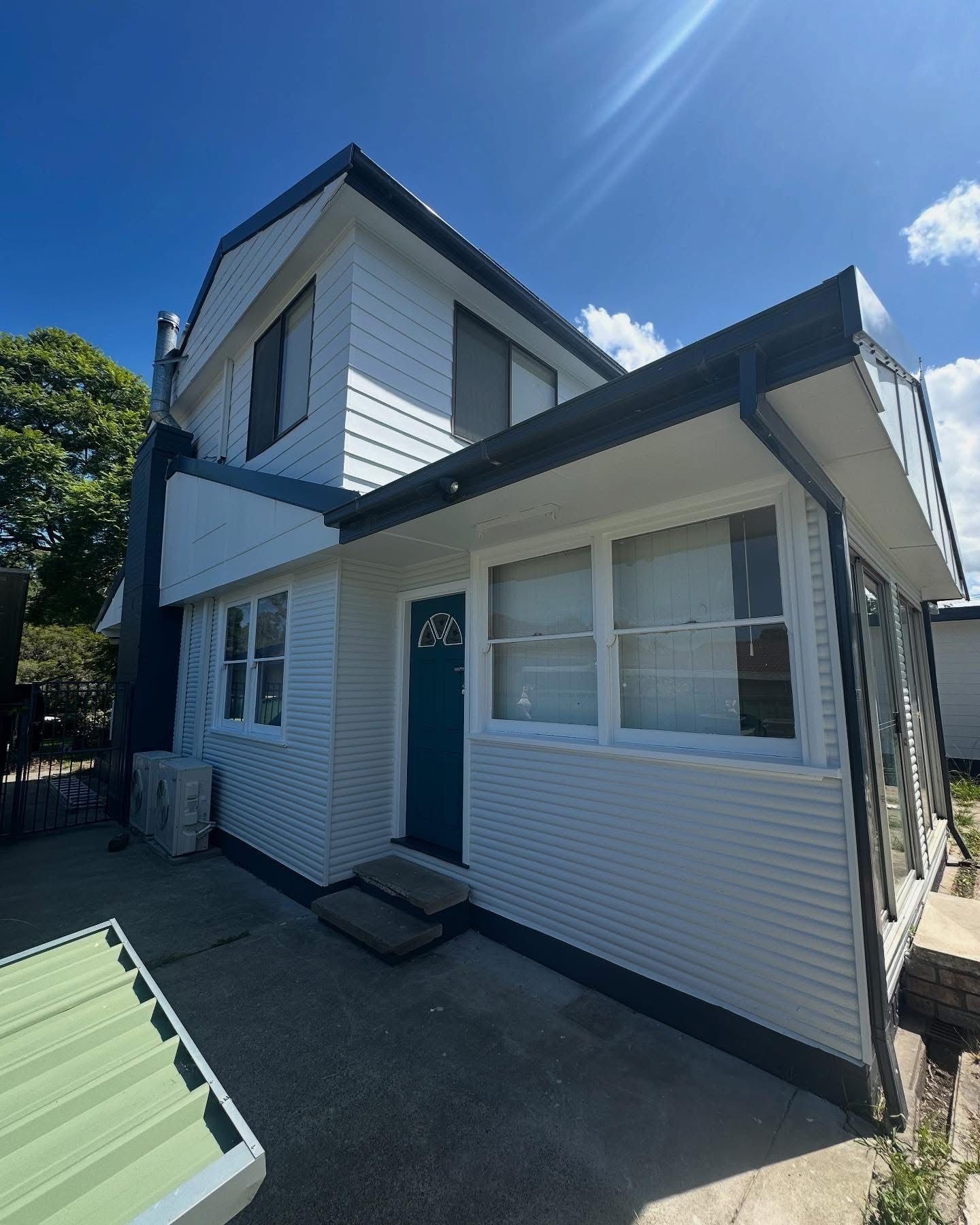 Half painted room with ladder and tin of paint — Blake Saunders Painting In Edgeworth, NSW