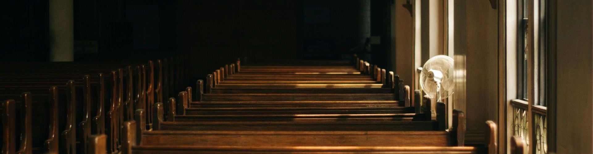 A row of wooden benches in a church.