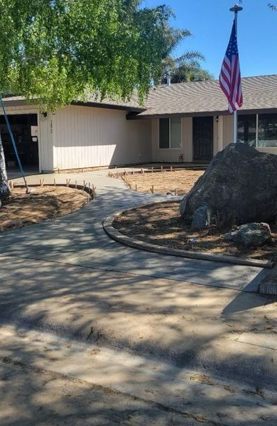 An american flag is flying in front of a house.