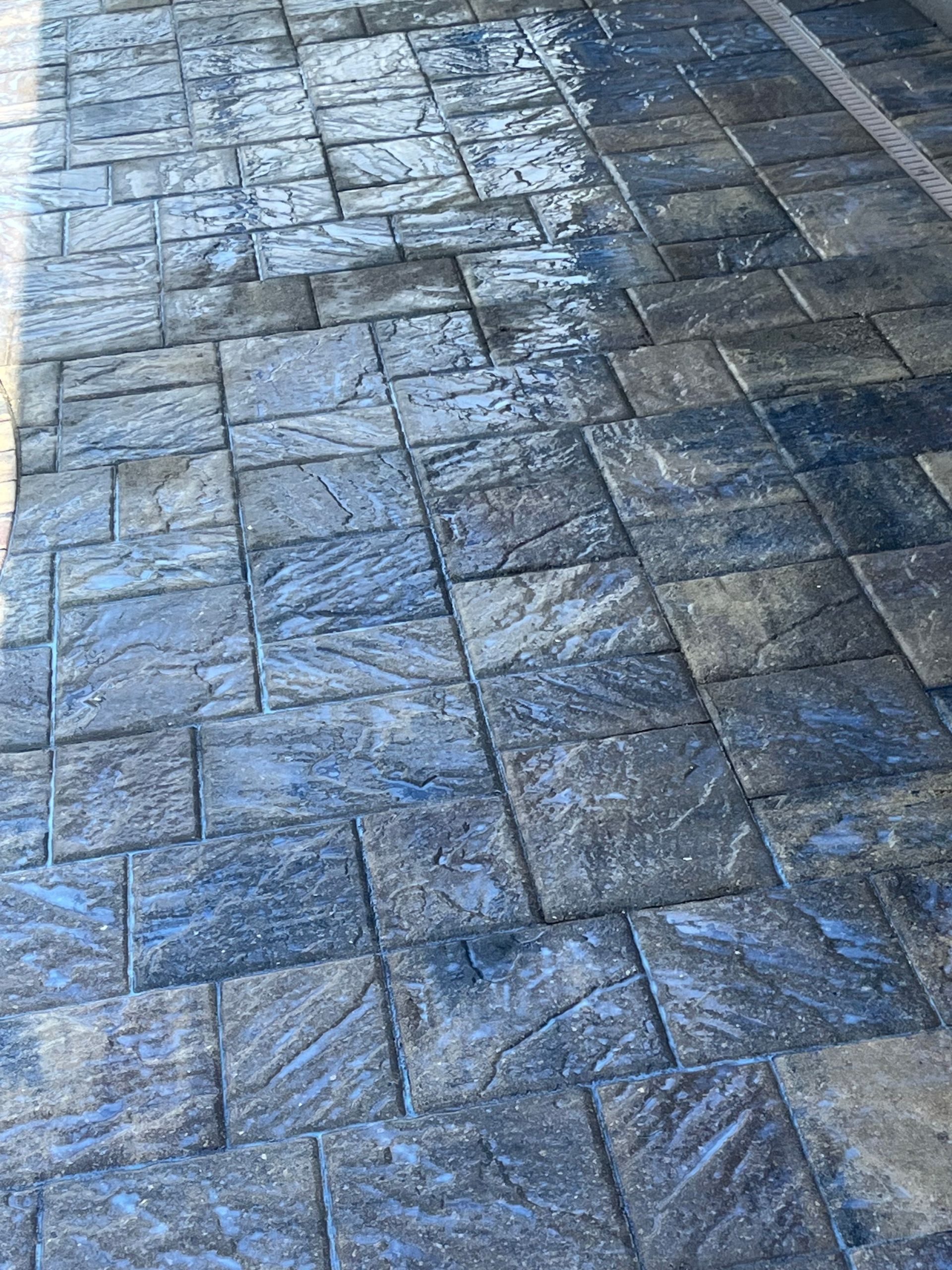 Textured blue and gray stamped concrete patio.