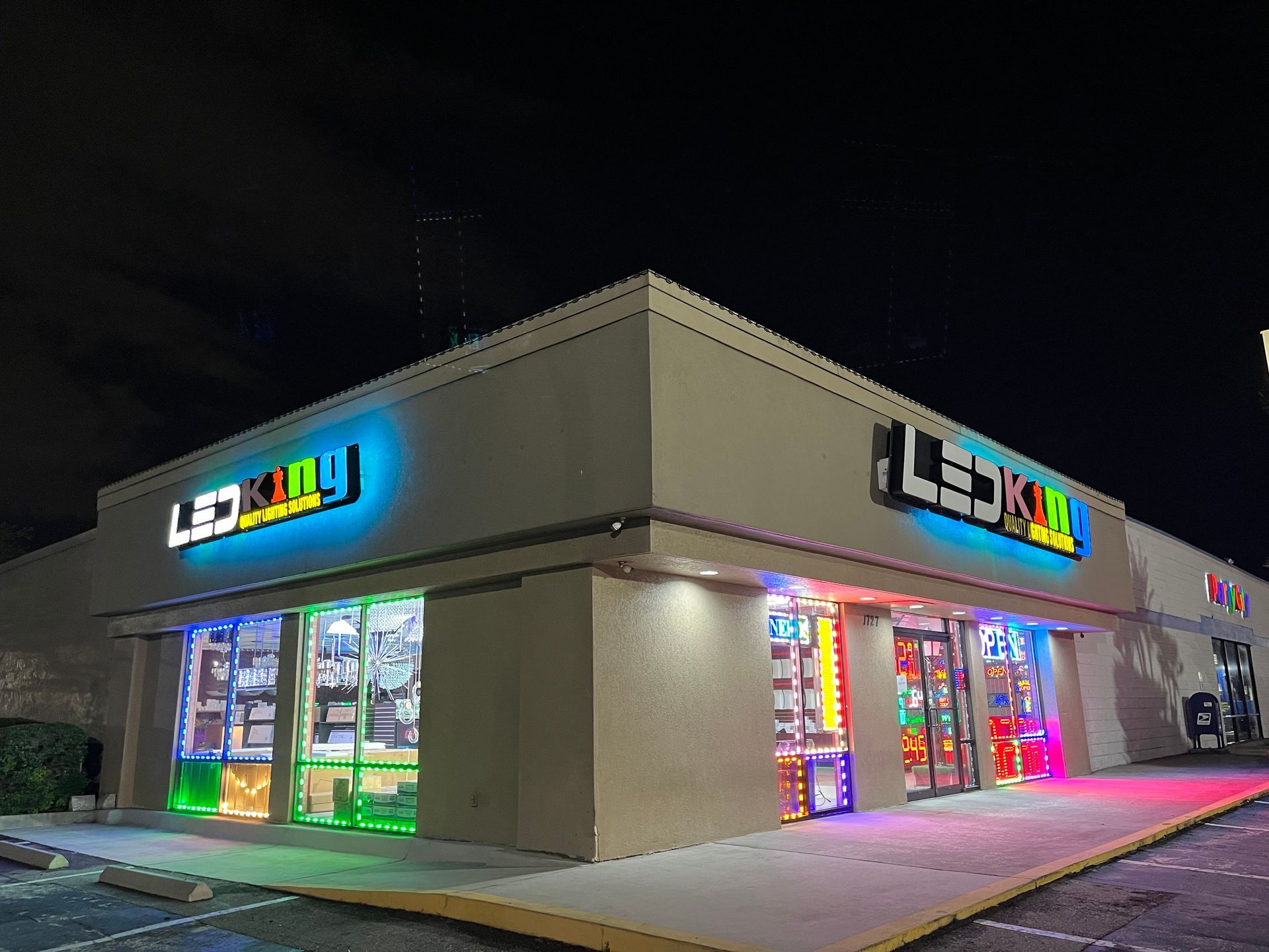 Exterior of LED King store at night with brightly lit LED displays in the windows and illuminated signage.