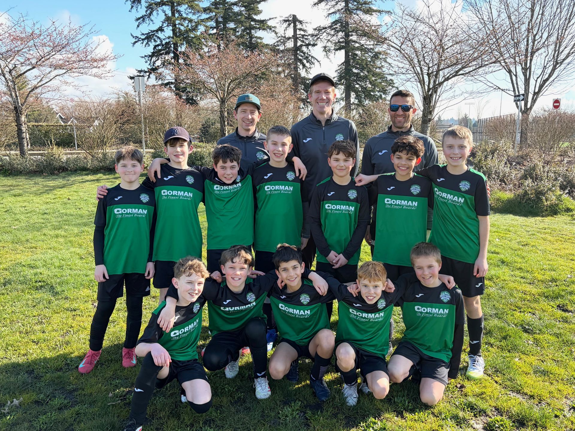 A group of children are posing for a picture under a canopy that says www.wysa.ca