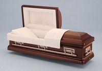 a brass casket with the lid open and a white blanket on it .