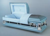 a light blue metal casket with the lid open is sitting on a table .