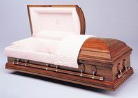 a wooden casket with the lid open on a white surface .