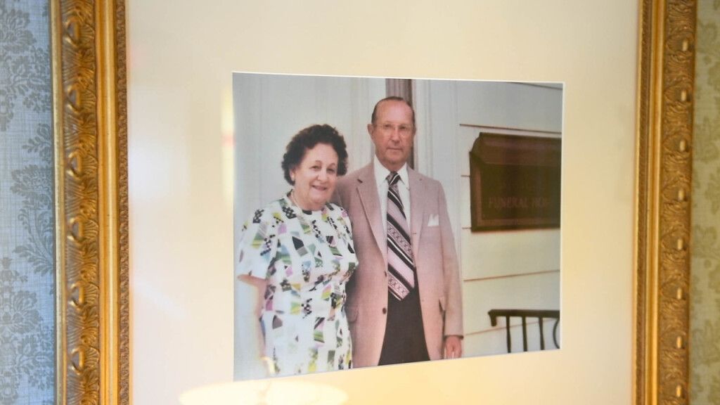 a framed picture of a man and woman standing next to each other