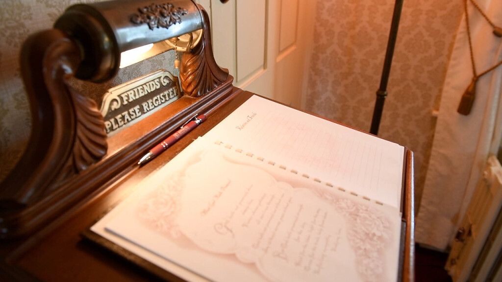 a desk with a lamp and a notebook that says