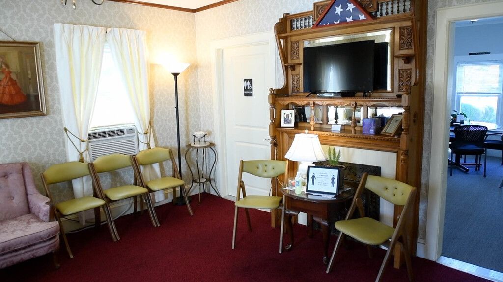 a living room with chairs and a flat screen tv