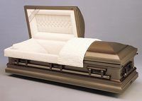 a brass casket with the lid open and a white blanket on it .