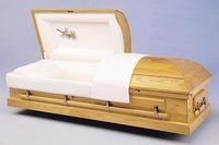 pine wood casket with the lid open on a white surface .