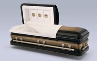 a black and gold casket with the lid open on a table .