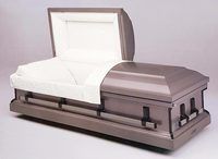 a coffin is open and sitting on a white surface .