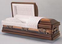 a brown coffin with the lid open is sitting on a table .
