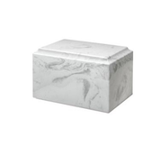 a white marble urn is sitting on a white surface .