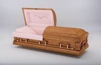 a wooden coffin with its lid open and pink liner