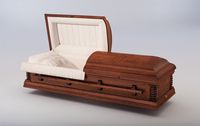 a brown casket with the lid open on a white surface .