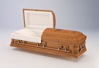 a wooden casket with the lid open on a white surface .