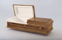 a brown casket with the lid open 