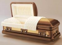 a brass coffin with the lid open and a white blanket on it .