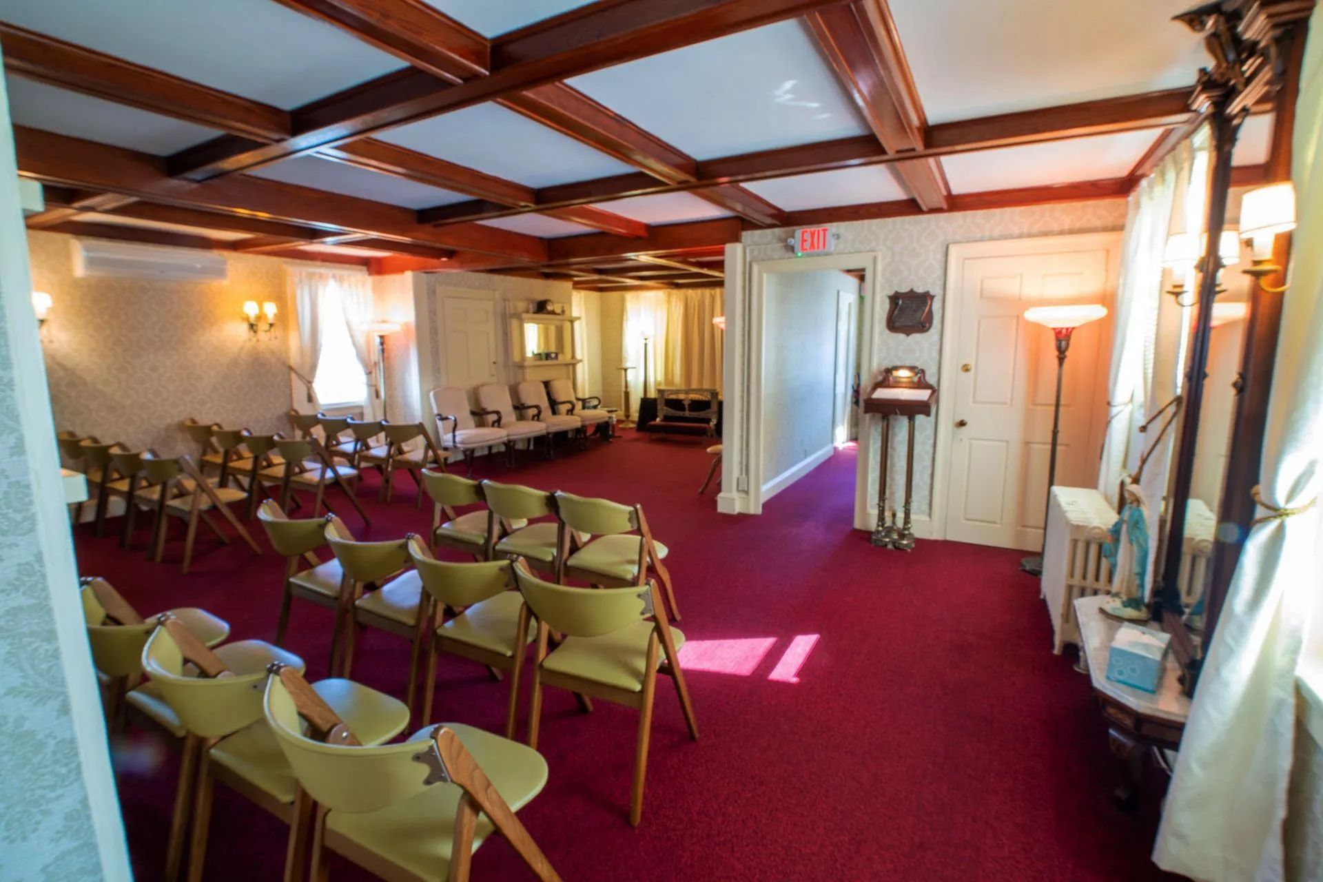 a room with rows of chairs and a red carpet