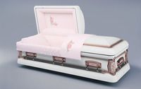a white coffin with a pink blanket on top of it .