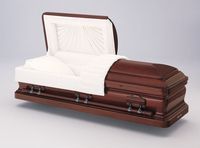 a wooden casket with the lid open on a white surface .