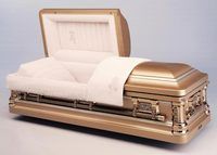 a gold coffin with the lid open and a white blanket .