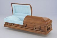 a wooden casket with the lid open with blue liner