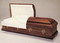 a wooden casket with the lid open on a white surface .