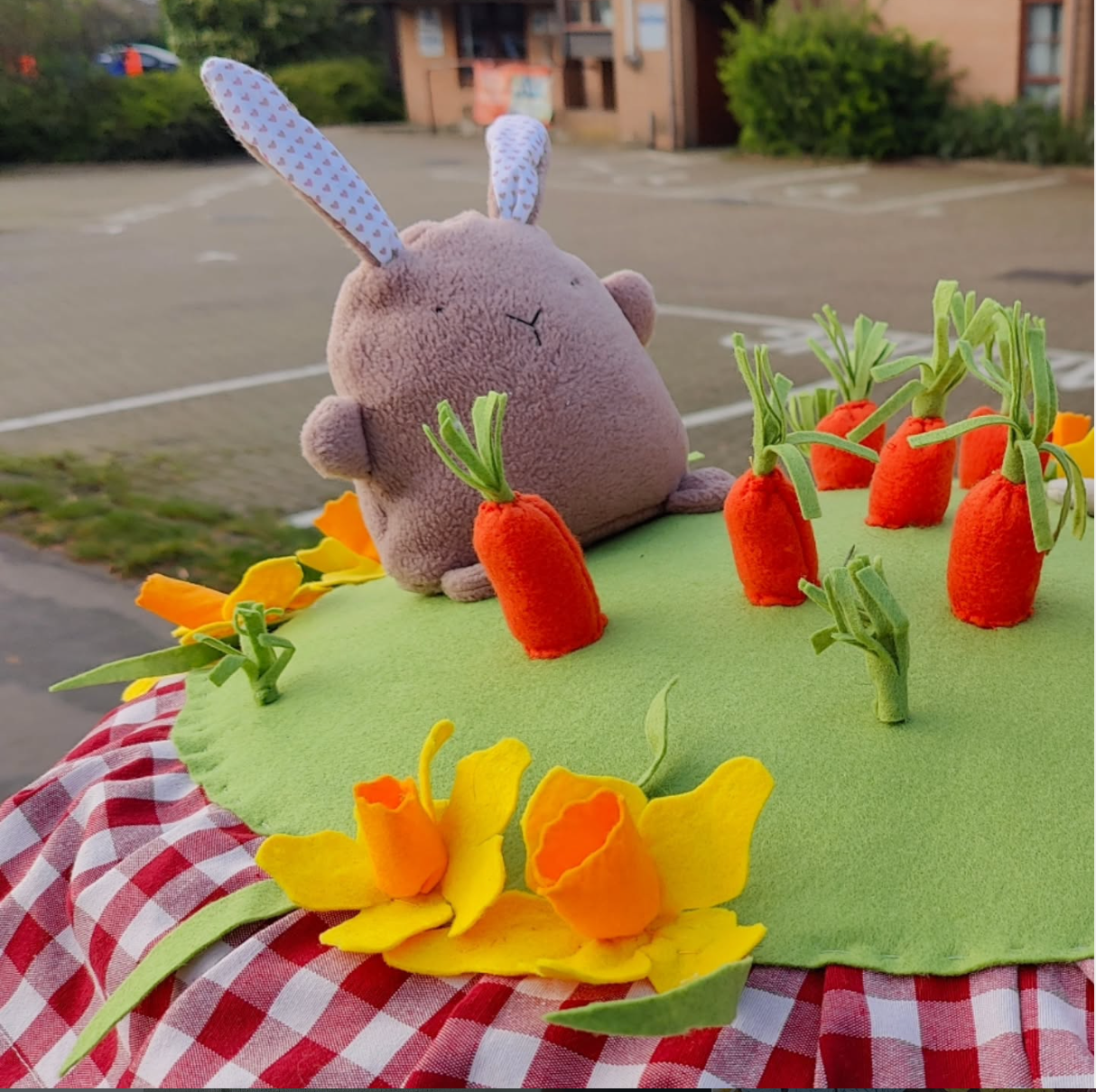 postbox topper with an easter theme featuring a fabric chinky fabric bunny and felt daffodils a nd carrots