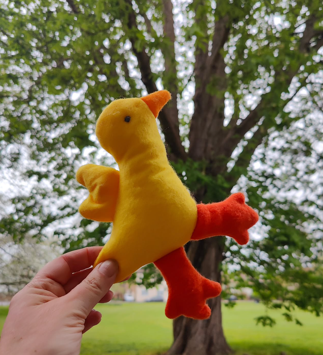 duck held in front of tree on the green, West drayton