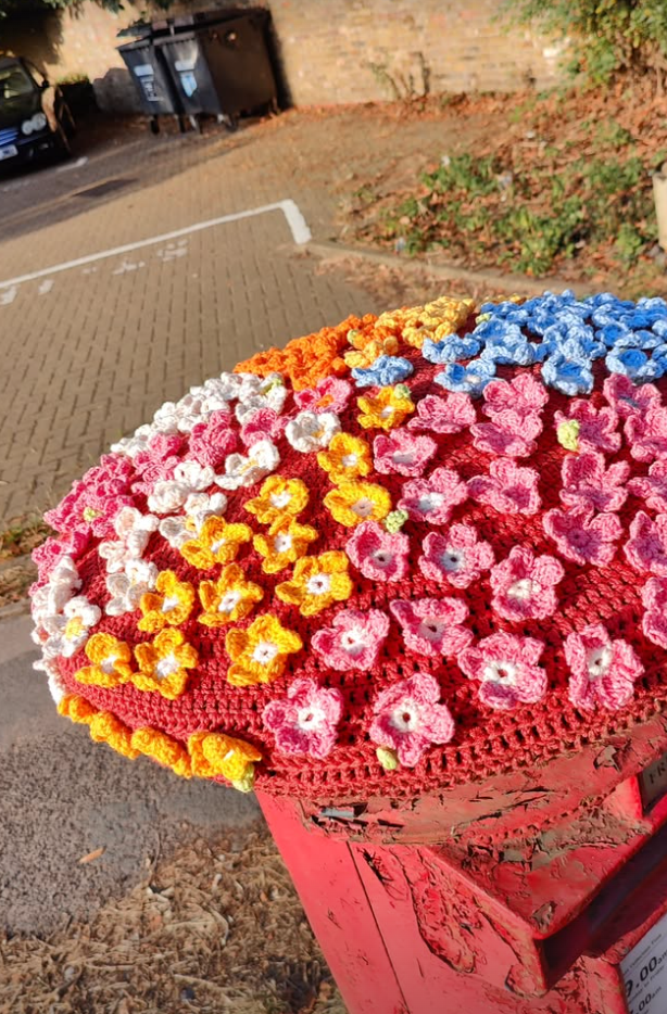 colourful crochet flowers on a postbox topper, Iver Hight Street
