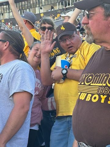 People are Standing and Enjoying in the Stadium — Cheyenne, WY — Treasure Abilities
