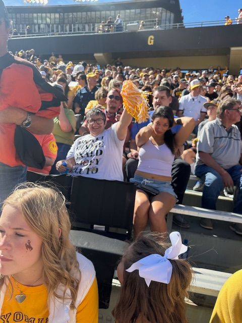 A crowd of people are Sitting in a Stadium — Cheyenne, WY — Treasure Abilities