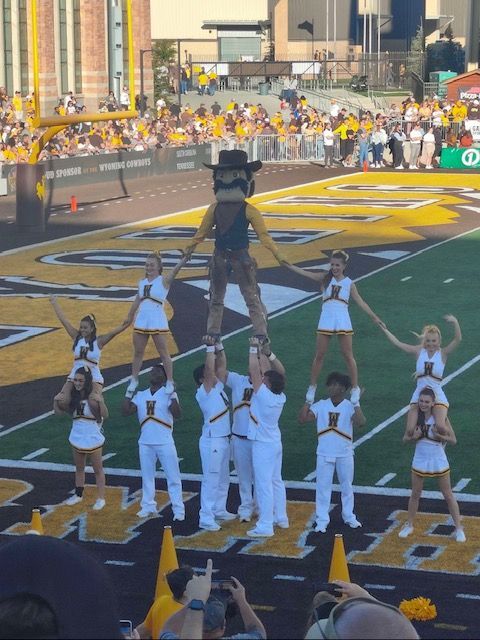 A Group of Cheerleaders are Performing on a Football Field — Cheyenne, WY — Treasure Abilities