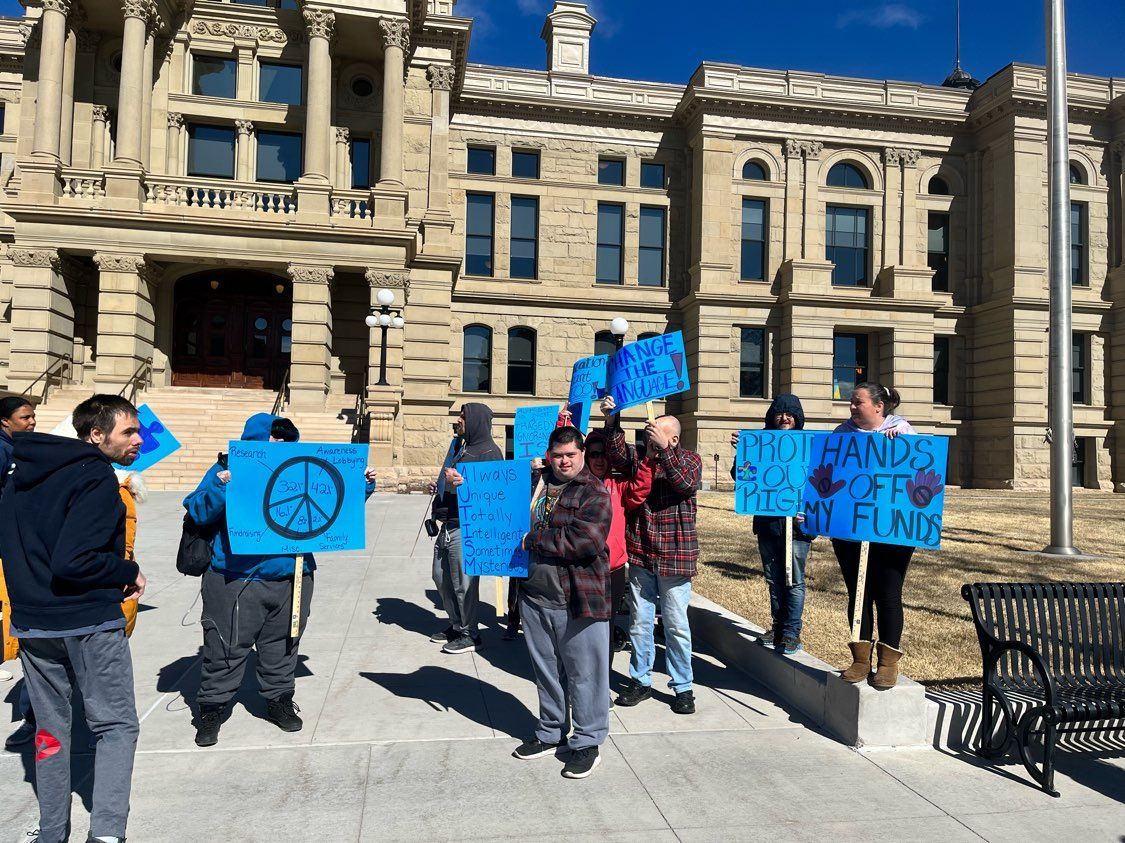 Group of People Holding Signs — Cheyenne, WY — Treasure Abilities