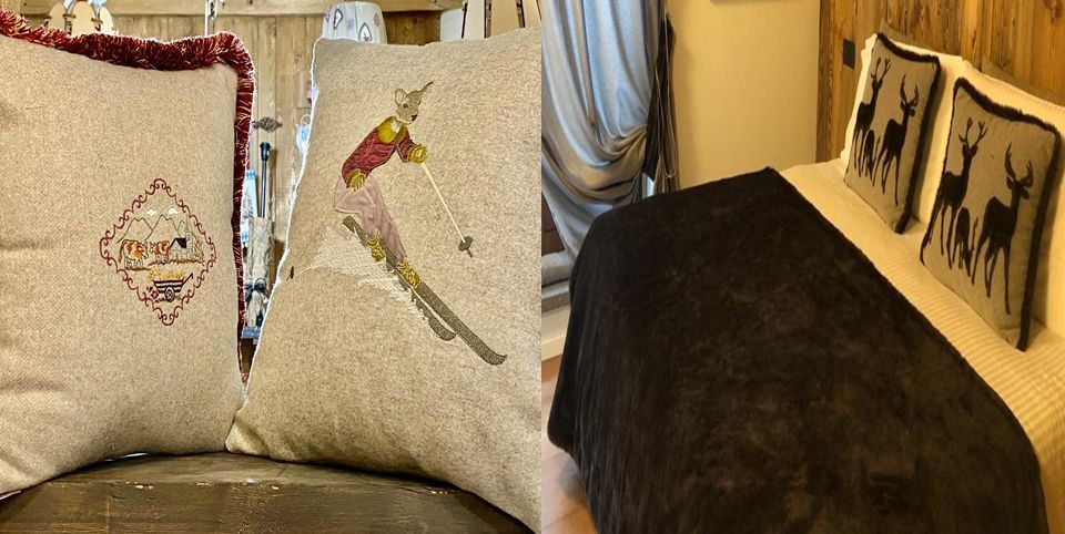 Un cuscino con uno sciatore sopra si trova su una sedia accanto al letto.