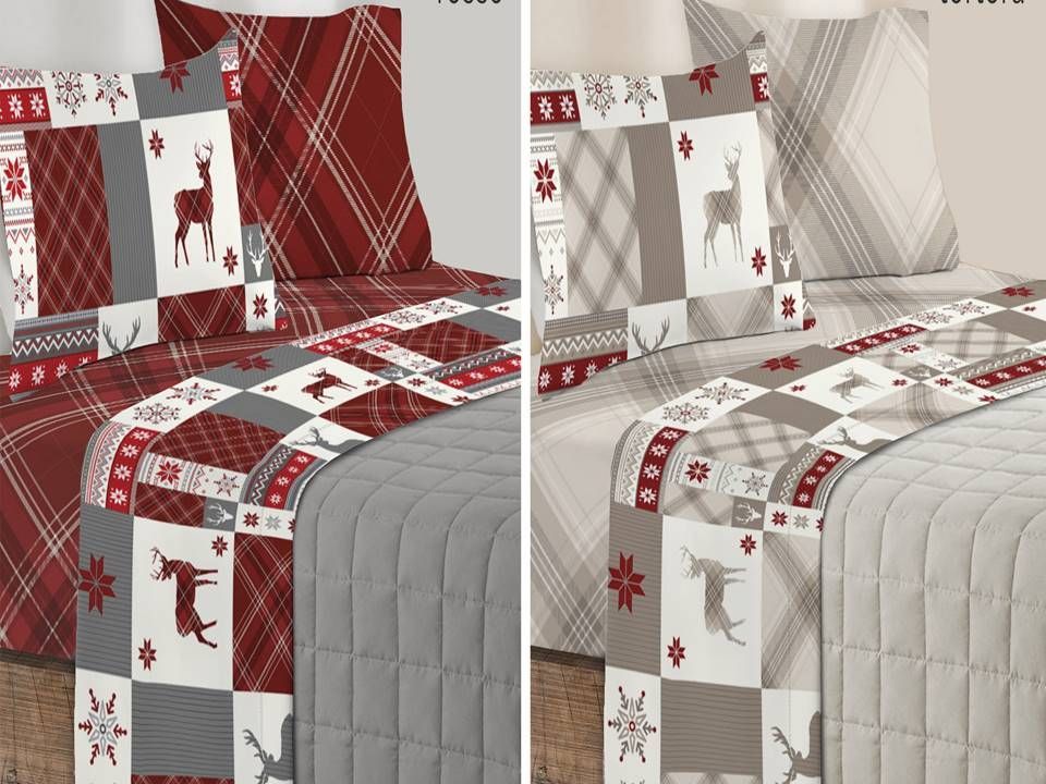 Un letto con una coperta e dei cuscini sopra